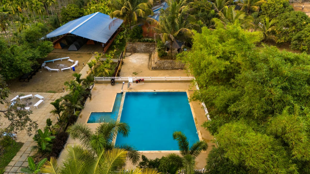 Aerial view of pool and property